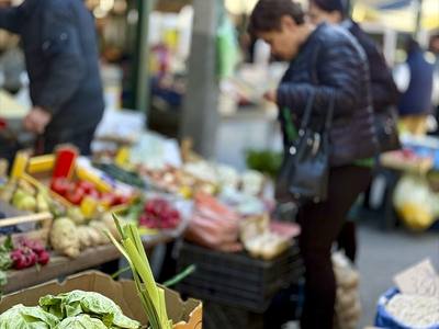 File:Market scene with shoppers browsing vegetables and fruits in an outdoor market undefined.jpg