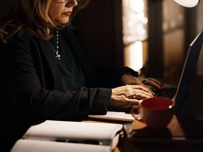 File:Middle-aged businesswoman typing on laptop at home office.jpg