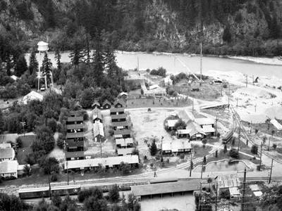File:Bird's-eye-view of settlement next to river showing buildings, train tracks, power lines and water tower, Alaska (AL+CA 6455).jpg