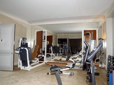 File:EFTA00000257 - Well-equipped home gym featuring various exercise machines free weights and mirrors on the wall.jpg