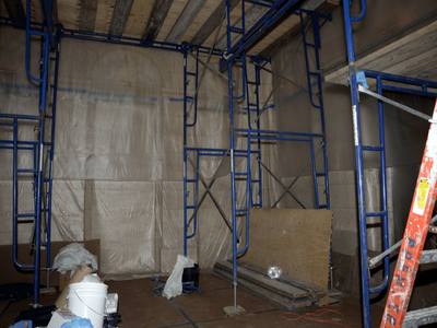 File:EFTA00000196 - Construction site with blue scaffolding plywood and tools scattered on the floor enclosed by protective plastic sheeting.jpg