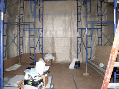 File:EFTA00000636 - Construction site with blue scaffolding cardboard barriers tools and materials on the floor.jpg